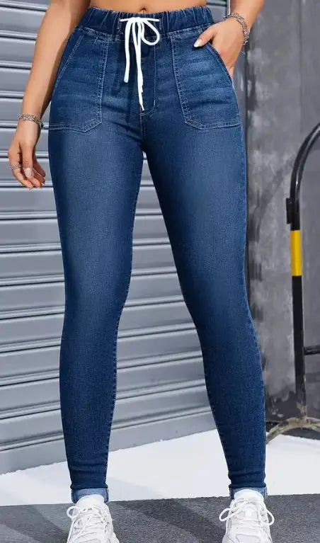 Women's high-waisted skinny jeans with drawstring waist, elastic cuffs, and slimming fit